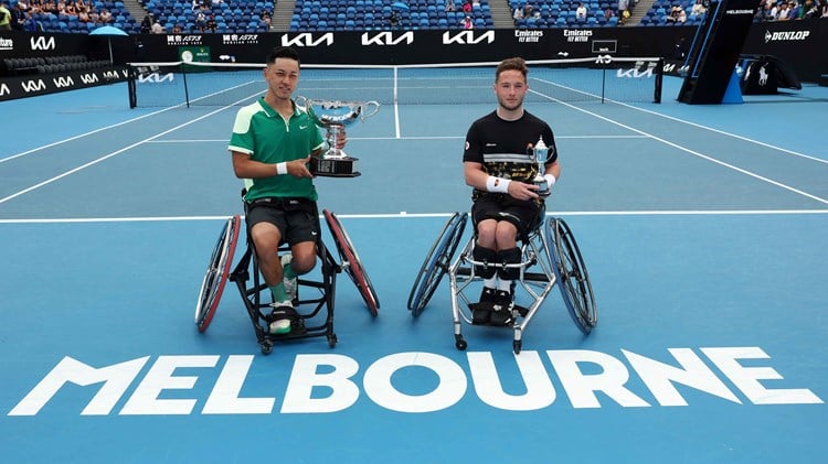 Tokito Oda and Alfie Hewett sat holding their trophies on court at the Australian Open
