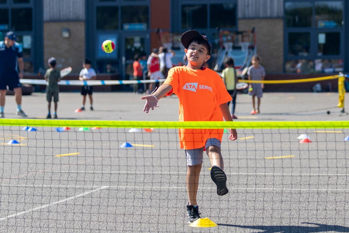 Child plays on court in an LTA SERVES programme