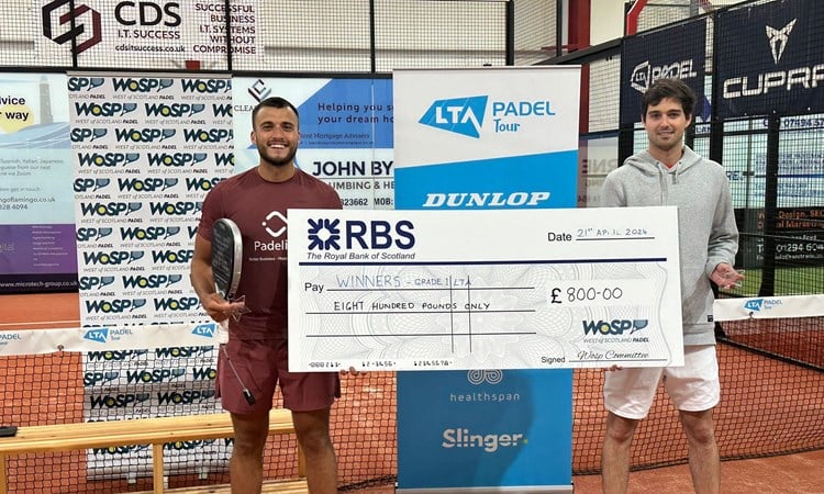 Louie Harris holding a giant cheque after winning the LTA British Tour Padel Stevenson title
