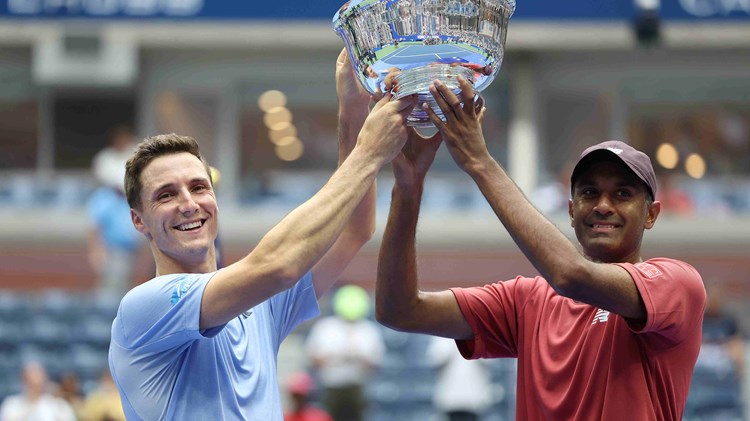 Joe Salisbury and Rajeev Ram lifting their championship trophy on court at the US Open