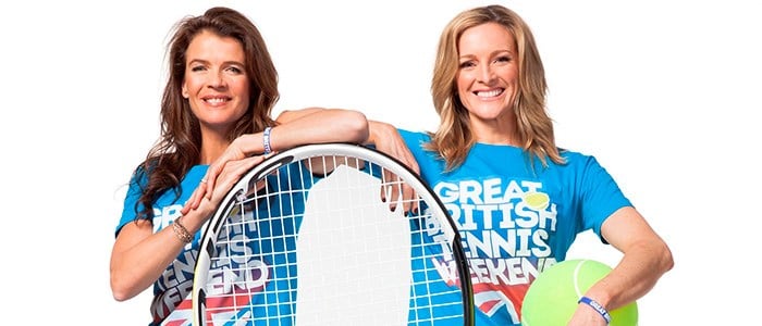 Gabby Logan and Annabel Croft smiling with their arms resting on a tennis tennis racket and holding a giant tennis ball