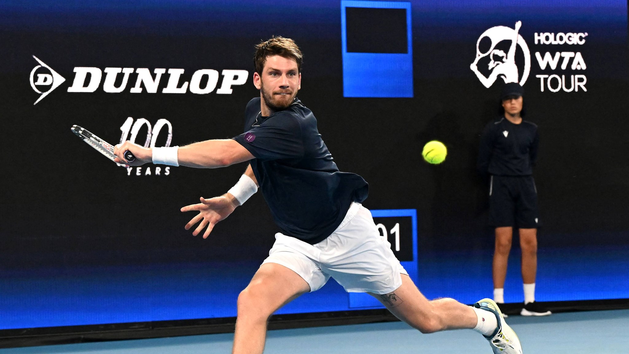 Cam Norrie stretches for a backhand against Taylor Fritz at the United Cup