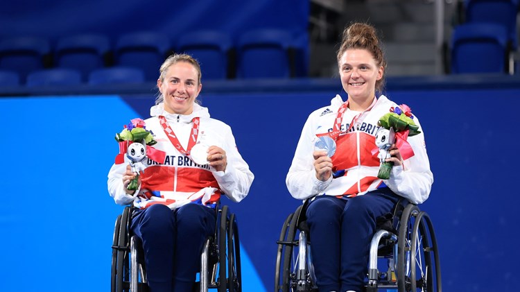Silver medalist Lucy Shuker (L) and Jordanne Whiley of Team Great Britain celebrate during the medal ceremony for the Women's Doubles Gold Medal Match on day 11 of the Tokyo 2020 Paralympic Games a