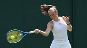 Mika Stojsavljevic hitting a forehand on court at the Championships at Wimbledon, having received a wild card to the main draw