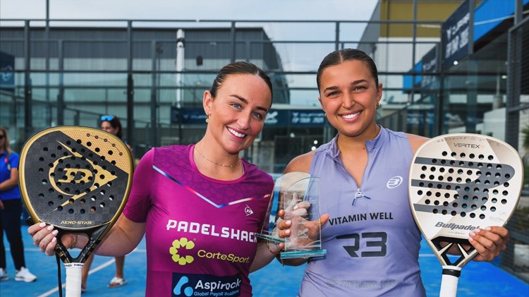 British Padel players Aimee Gibson and Catherine Rose smiling while holding their padel rackets and the FIP Silver Australian Padel Open trophy