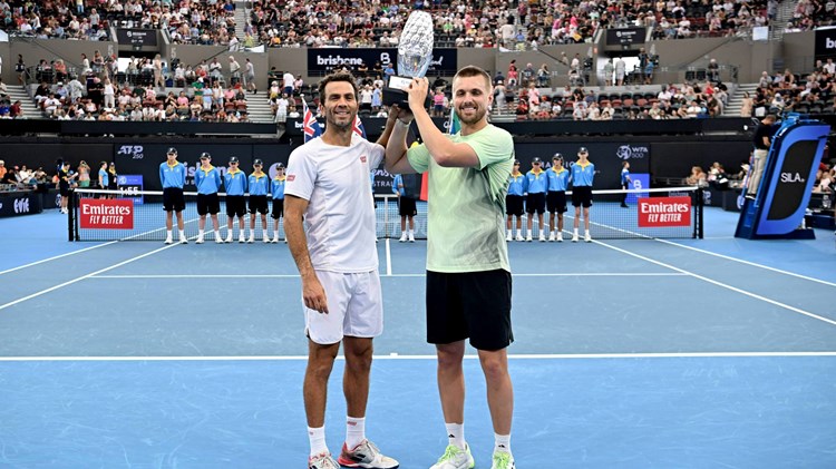 Jean-Julien Rojer and Lloyd Glasspool holding the Brisbane International title