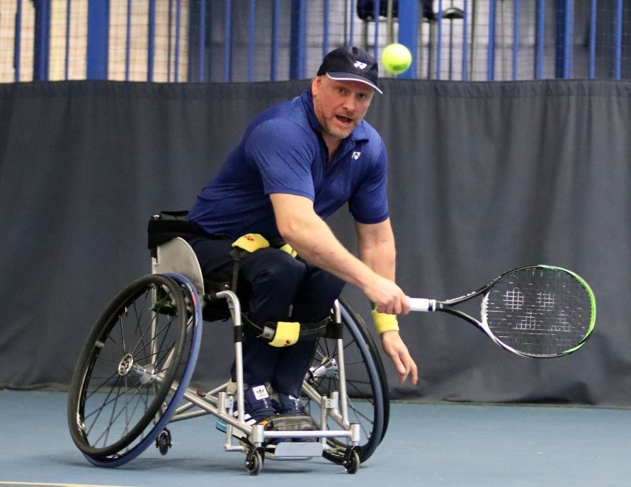 Wheelchair player about to take a backhand shot