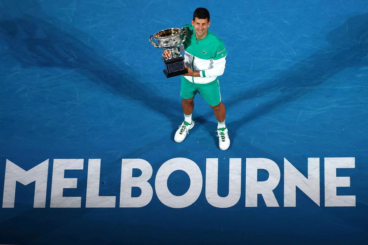 Novak Djokovic holding the championship trophy at the 2020 Australian Open 