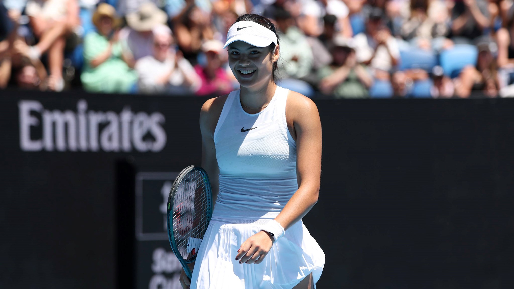 Emma Raducanu smiles on court during her second round clash with Amanda Anisimova at the Australian Open