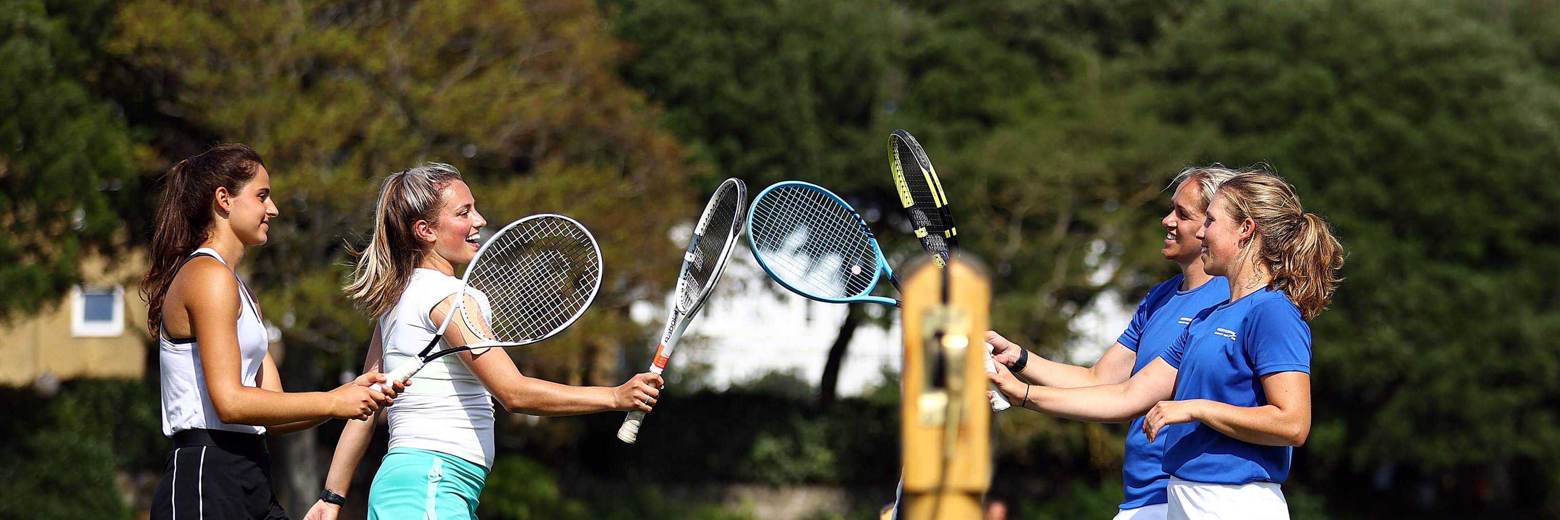 Doubles players tapping rackets over net at Devonshire Park Eastbourne