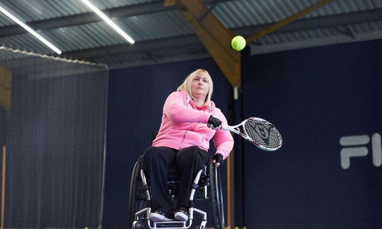 Female wheelchair player about to take backhand shot