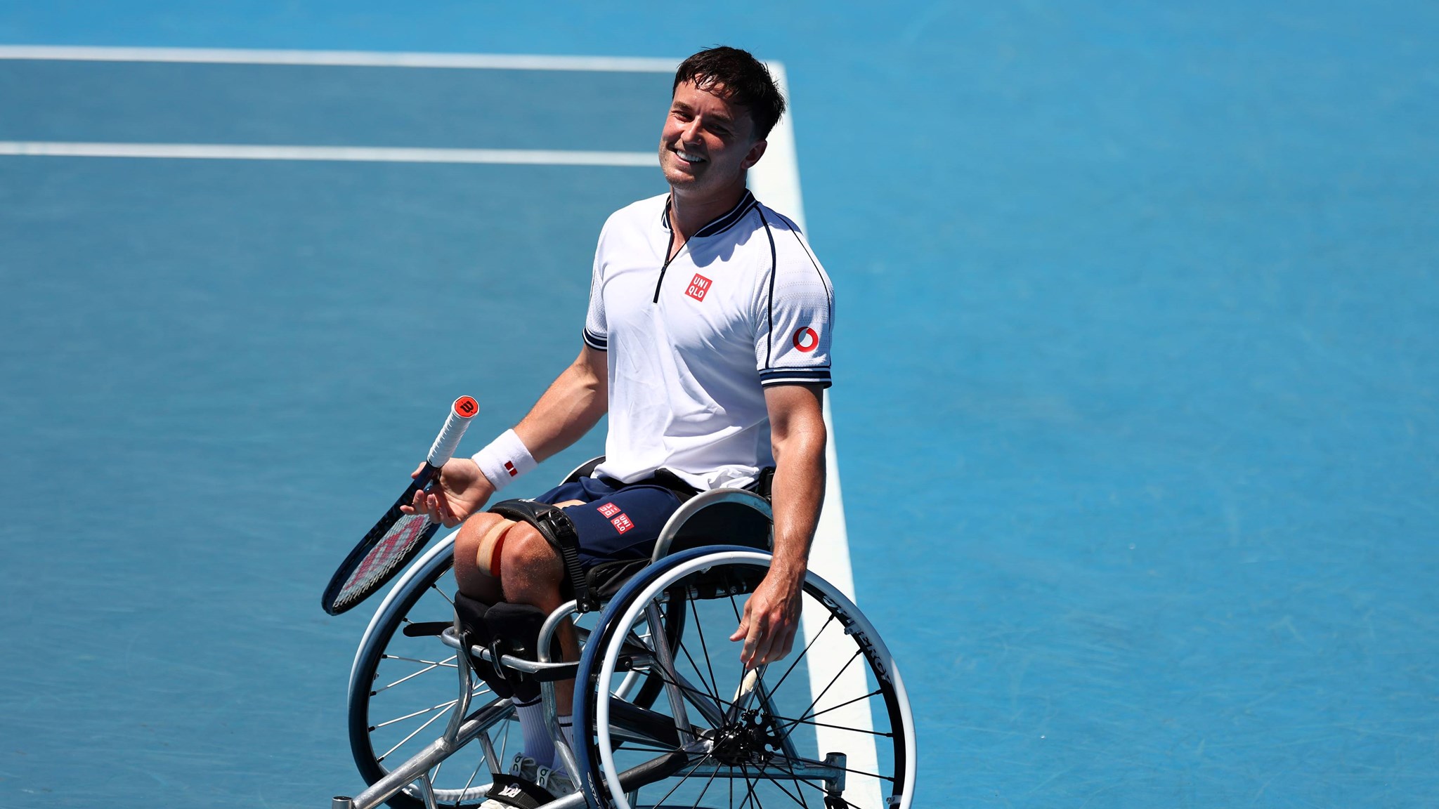 Gordon Reid sat in his wheelchair on court while smiling at the Australian Open