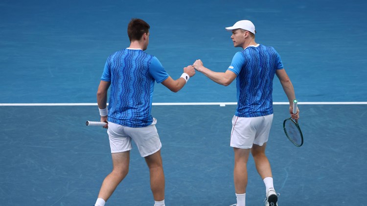 Henry Patten and Harri Heliovaara fist bumping during the Australian Open semi-final