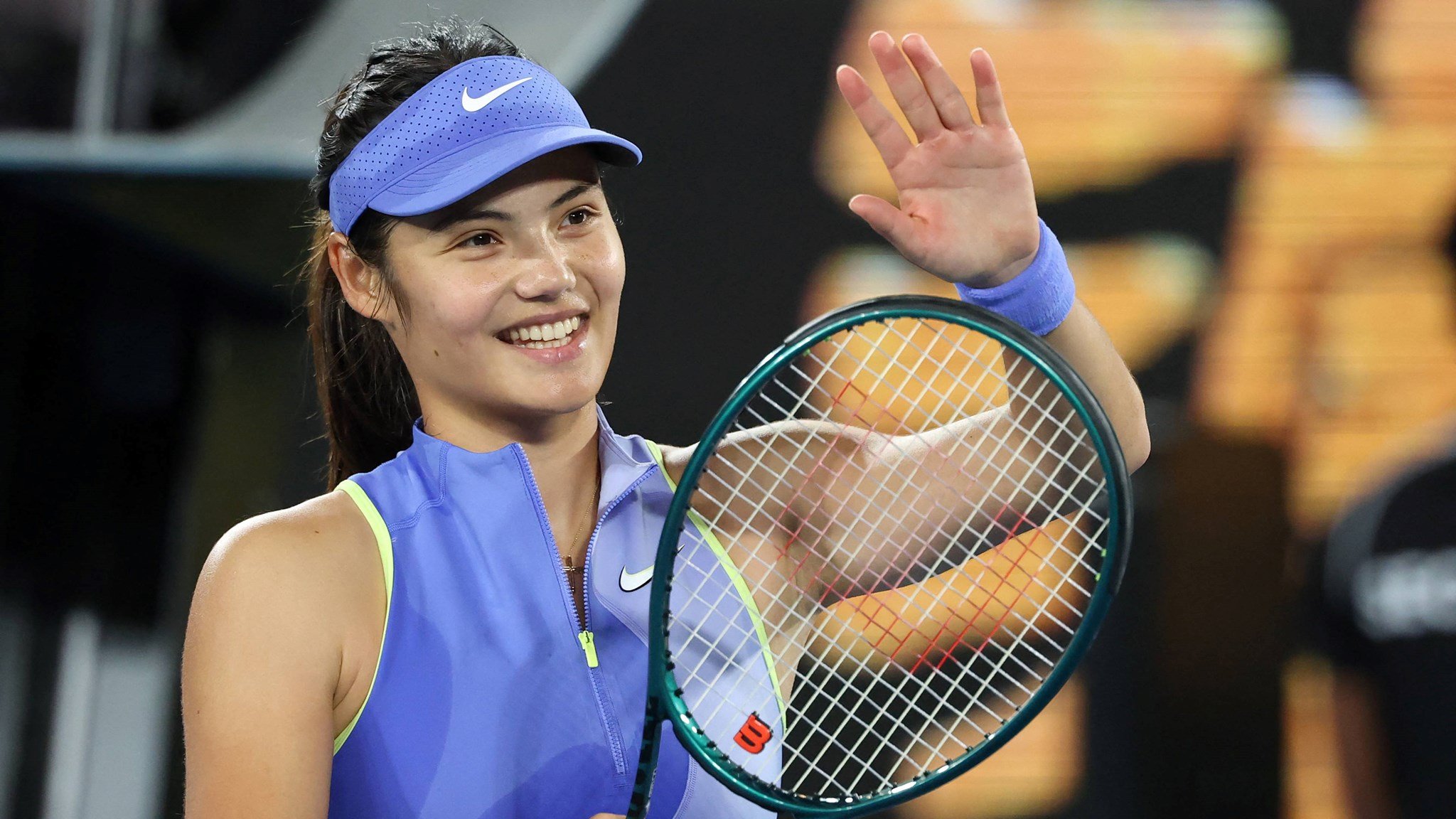 Emma Raducanu smiles and applaudes the crowd after a first round win at the 2026 Australian Open