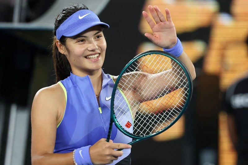Emma Raducanu smiles and applaudes the crowd after a first round win at the 2026 Australian Open