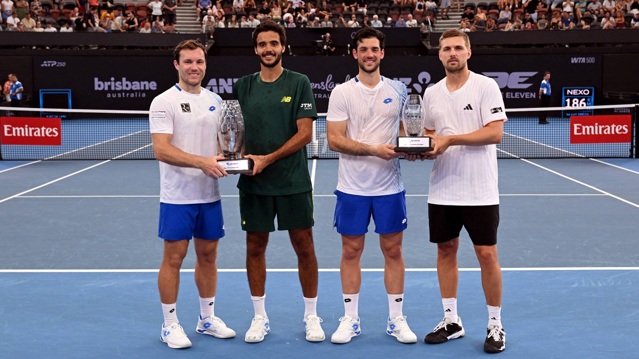 Julian Cash and Lloyd Glasspool holding the runner-up trophy at the Brisbane International