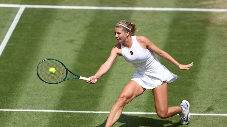 Hannah Klugman hits a volley on her Wimbledon debut