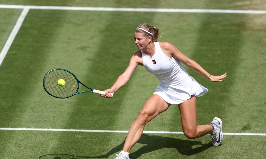 Hannah Klugman hits a volley on her Wimbledon debut