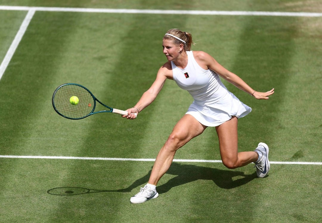 Hannah Klugman hits a volley on her Wimbledon debut