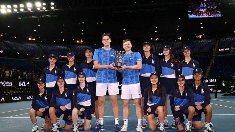 Hnery Patten and Harri Heliovaara holding the 2025 Australian Open men's doubles trophy