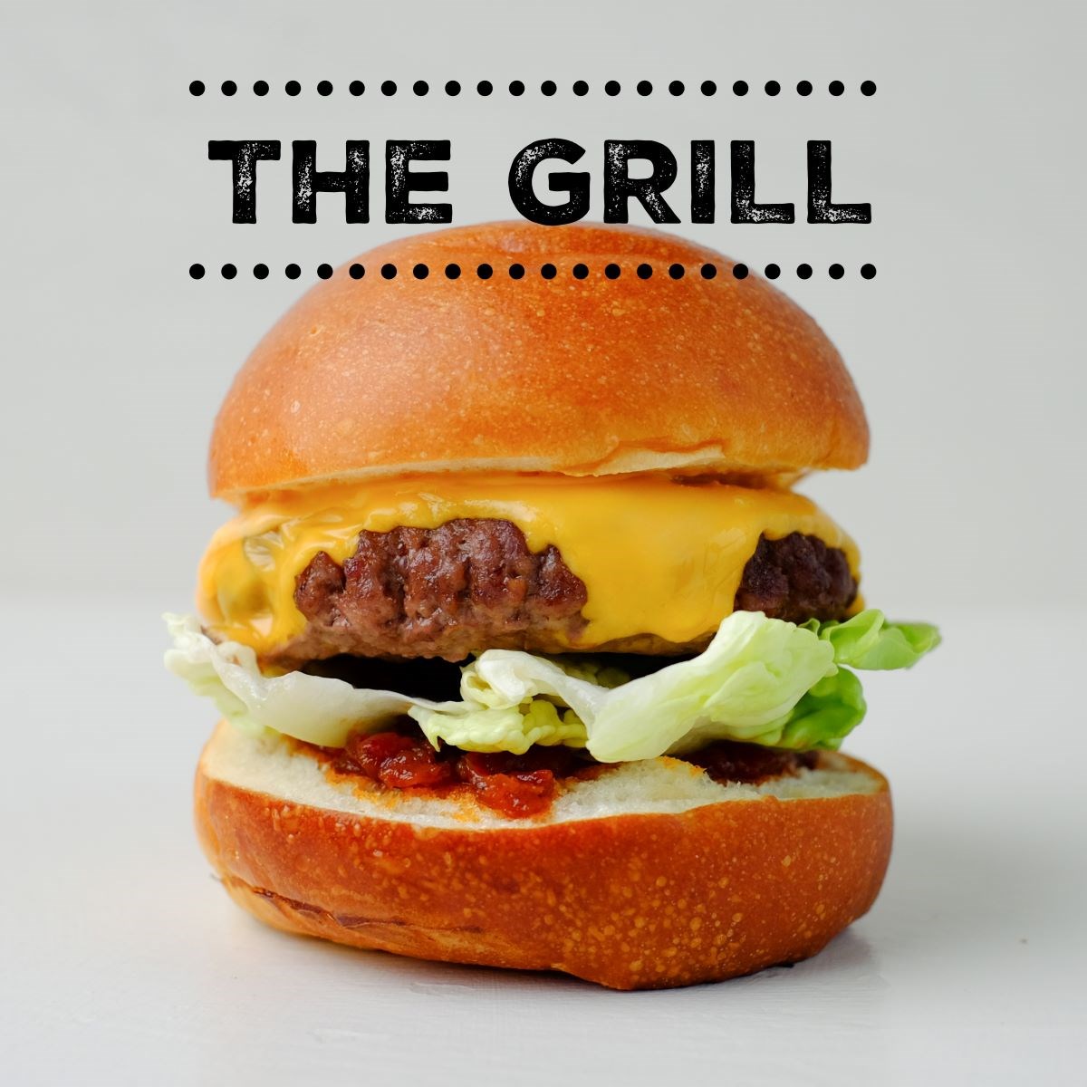 A cheese burger with lettuce from The Grill