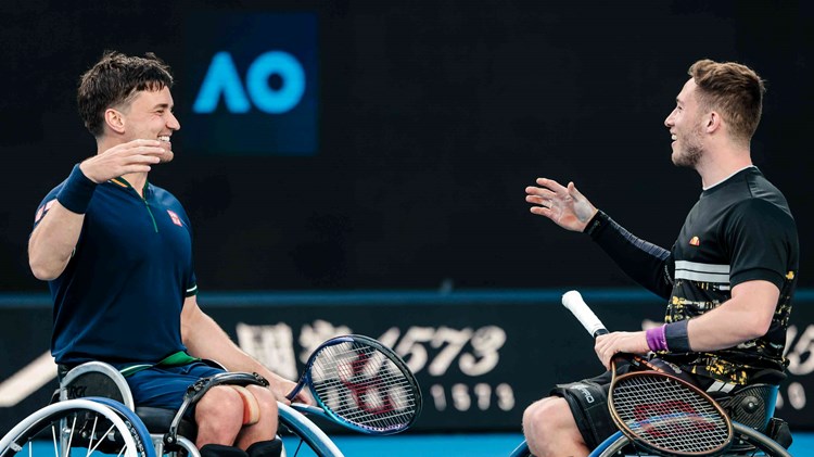 Alfie Hewett and Gordon Reid shaking hands on court after lifting their 5th successive Aus Open wheelchair doubles title