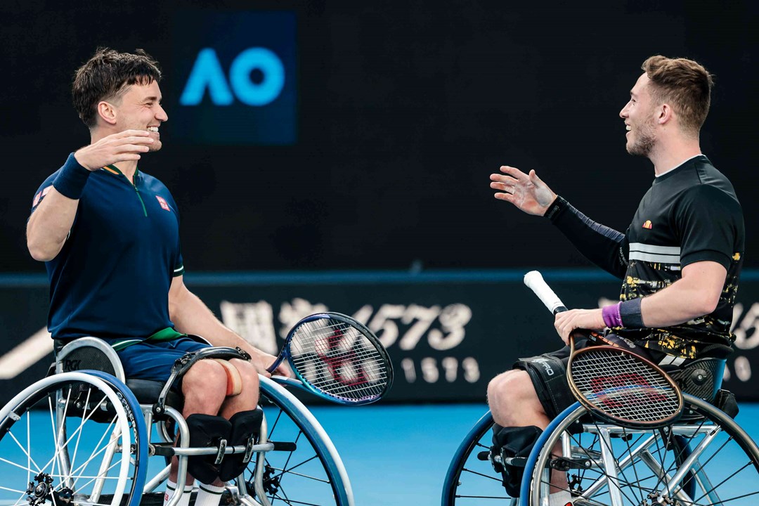 Alfie Hewett and Gordon Reid shaking hands on court after lifting their 5th successive Aus Open wheelchair doubles title