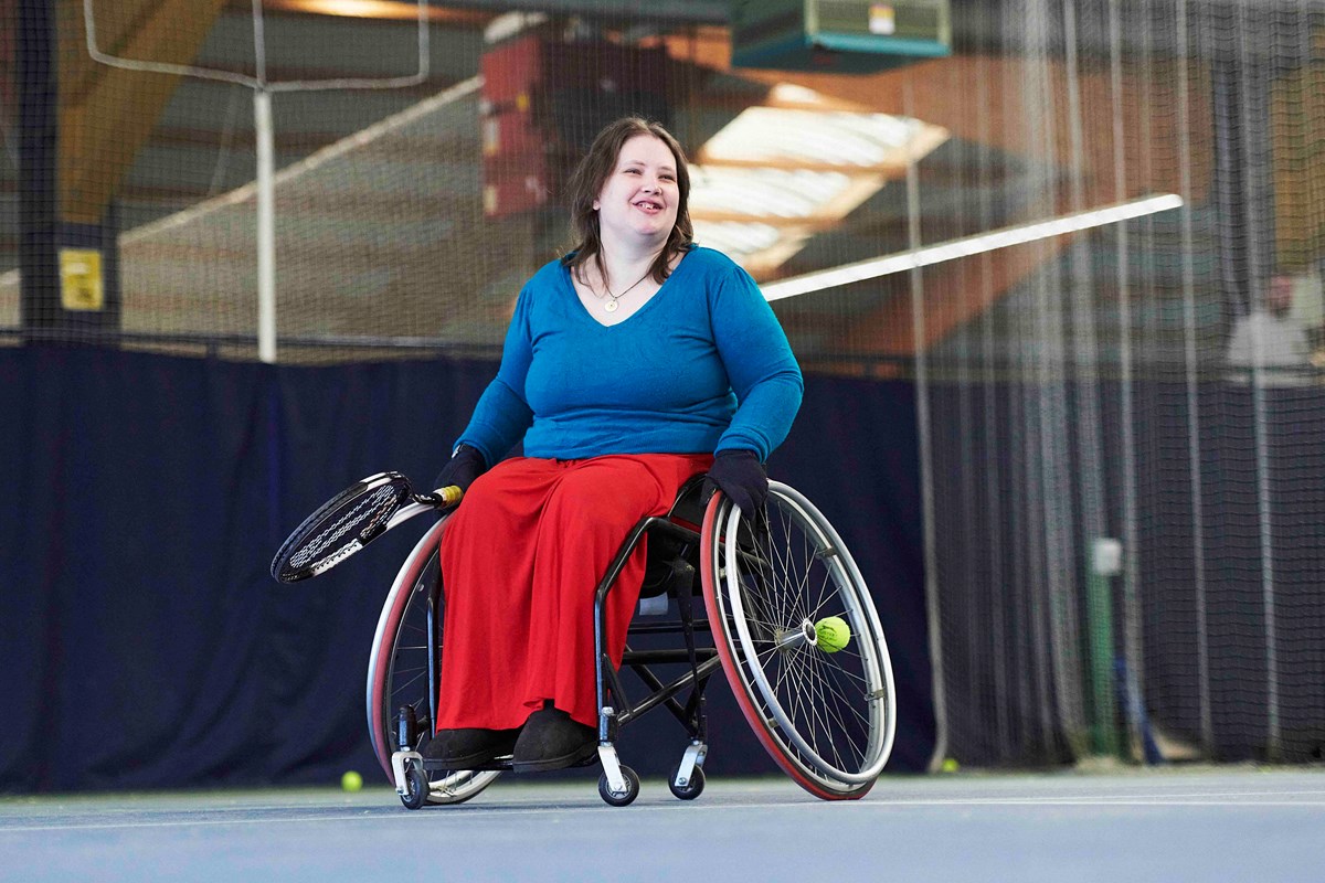 Wheelchair tennis player smiling on court.jpg