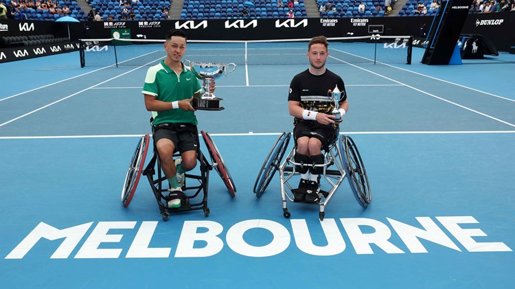 Tokito Oda and Alfie Hewett sat holding their trophies on court at the Australian Open