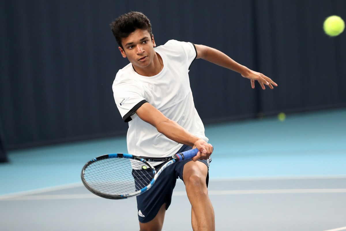 Young boy about to hit a forehand shot.jpg
