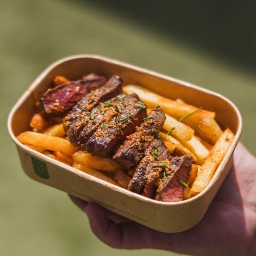 Steak and chips in a takeaway container
