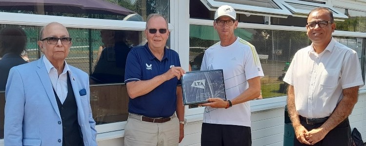 Group of men at Riverside Tennis Club with Mohammad Yasin and David Rawlinson holding the framed award