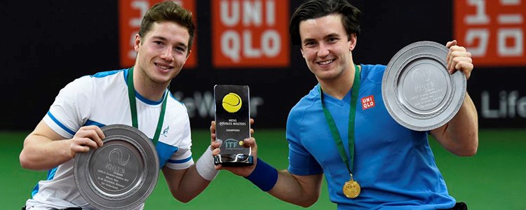Gordon Reid and Alfie Hewett with medal around their neck holding the ITF trophy