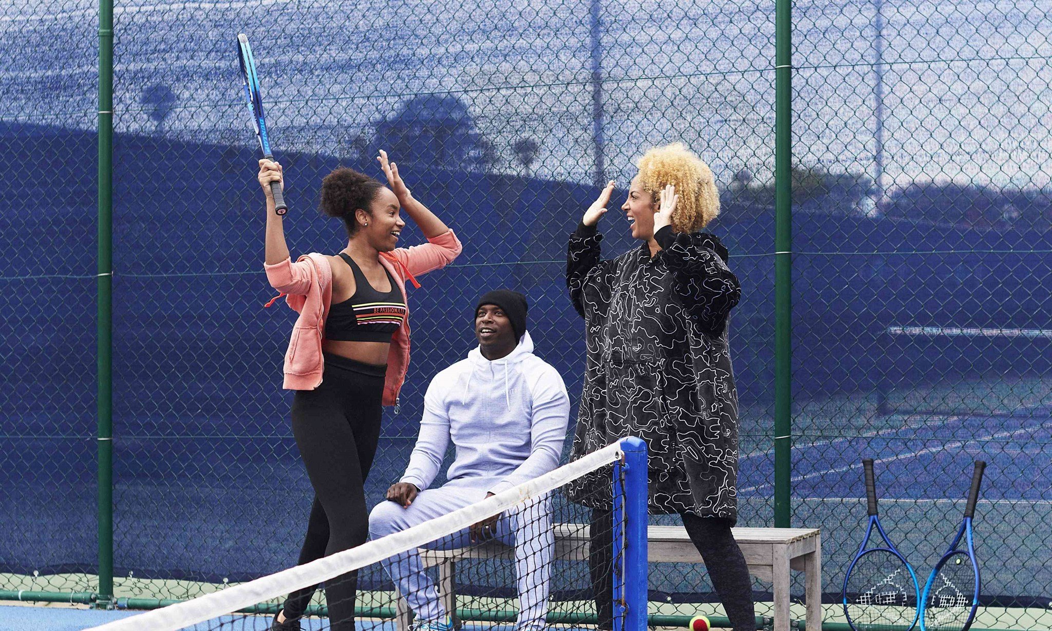 Parents and child celebrating on court