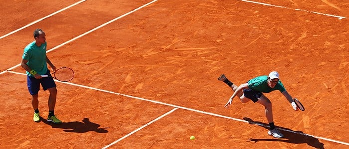 Jamie Murray reaching for the ball on the clay tennis court at the Monte-Carlo Rolex Masters 