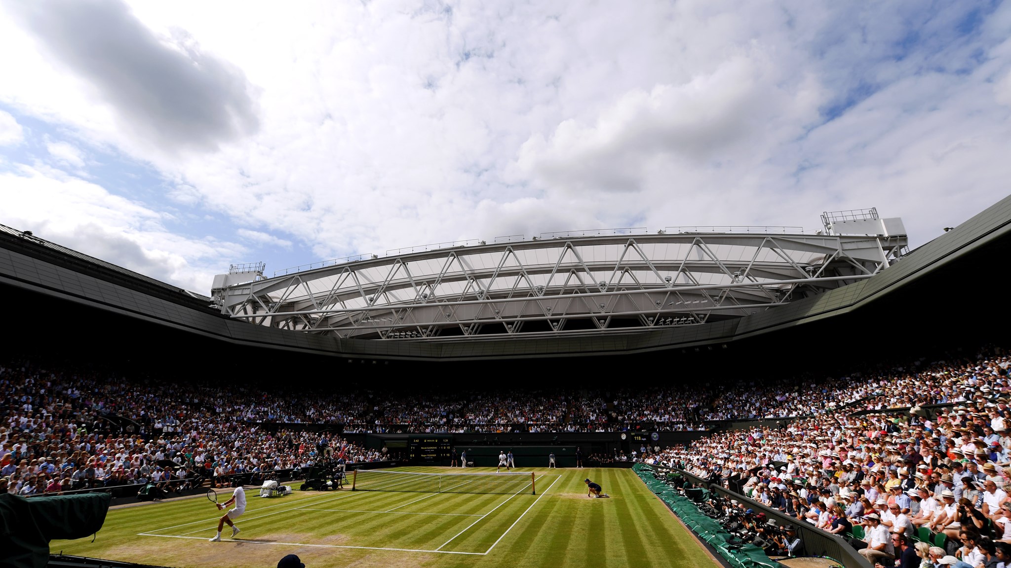 Wimbledon Centre Court full of spectators on a sunny day