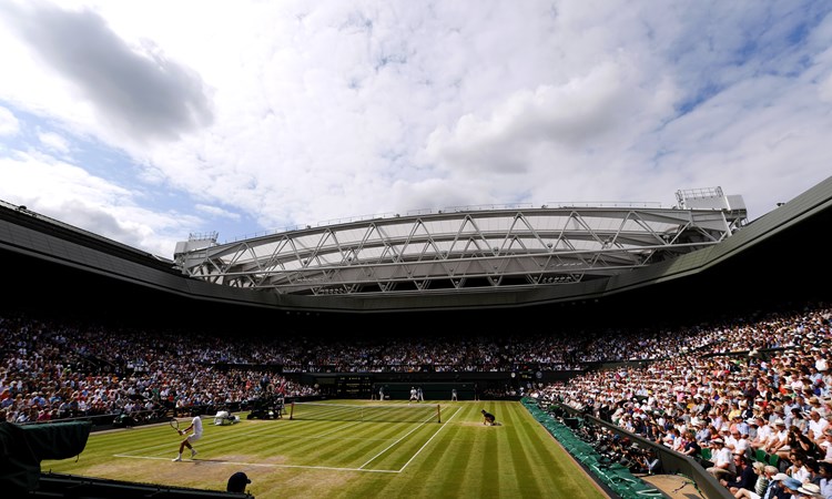Wimbledon Centre Court full of spectators on a sunny day
