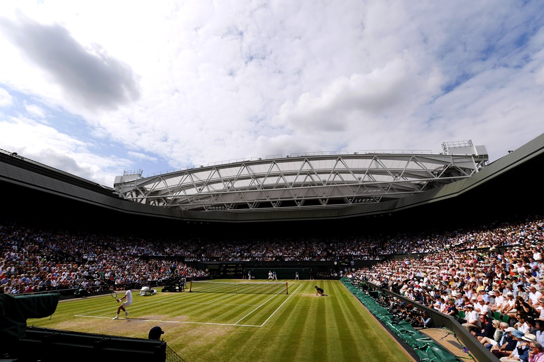 Wimbledon Centre Court full of spectators on a sunny day