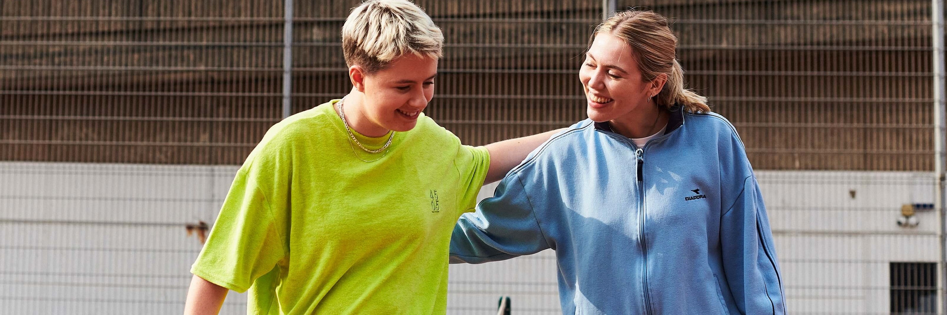 Two women patting each other on the back after a game of tennis