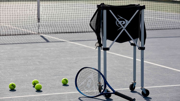 Tennis racket with a bag of balls