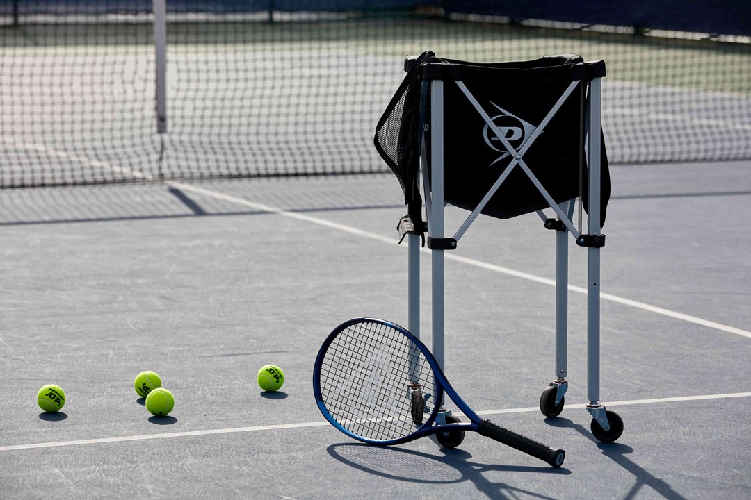 Tennis racket with a bag of balls