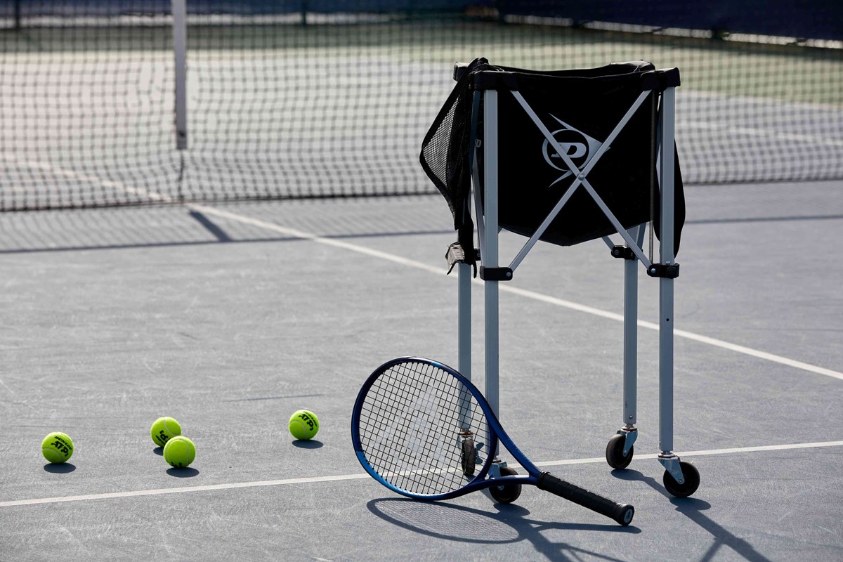 Tennis racket with a bag of balls.jpg