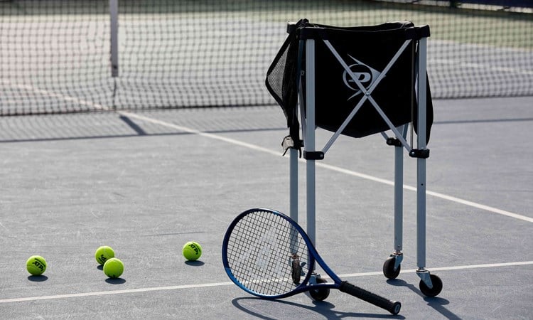 Tennis racket with a bag of balls