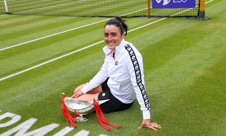 Ons Jabeur, women's champion of the  2021 Birmingham Classic, sitting on court with her trophy. 