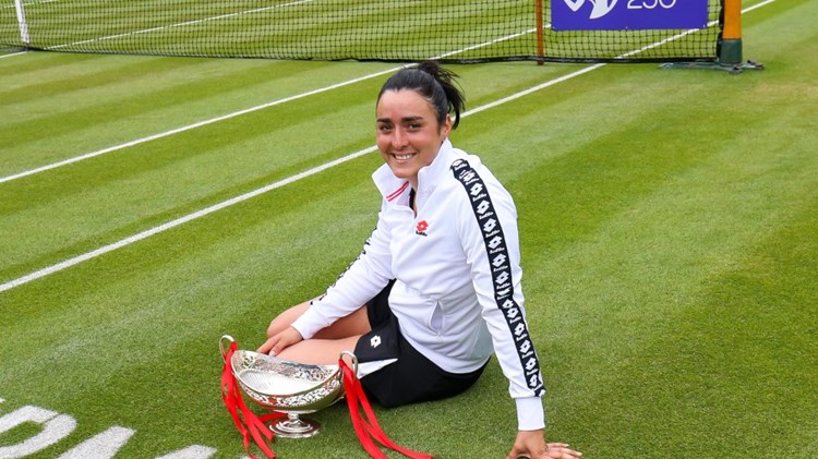 Ons Jabeur, women's champion of the  2021 Birmingham Classic, sitting on court with her trophy. 