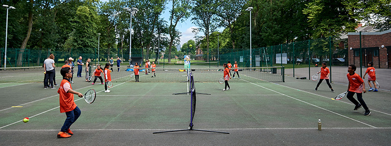 Kids rallying together at a park court