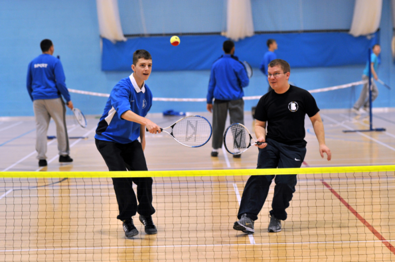 Two boys playing doubles together. 