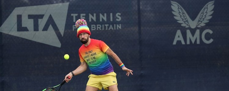 A male tennis player on court at the Pride in Tennis event at the National Tennis Centre