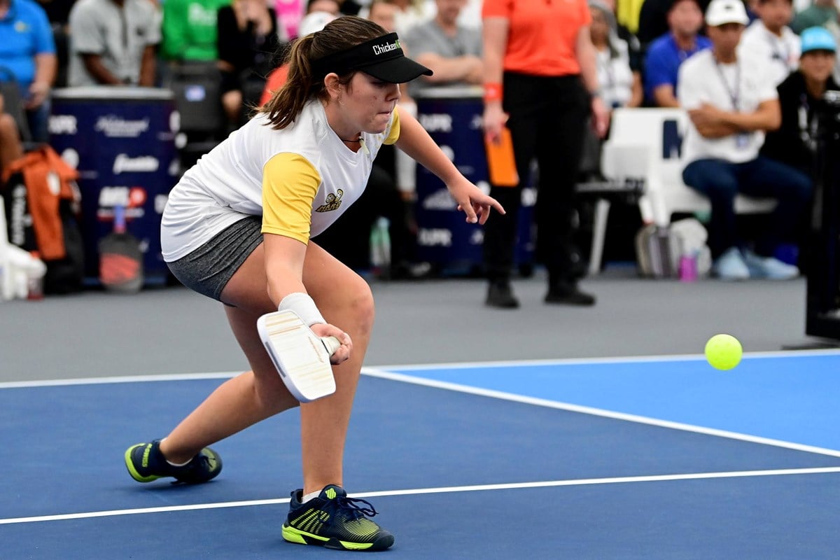 Pickleball player hitting the ball