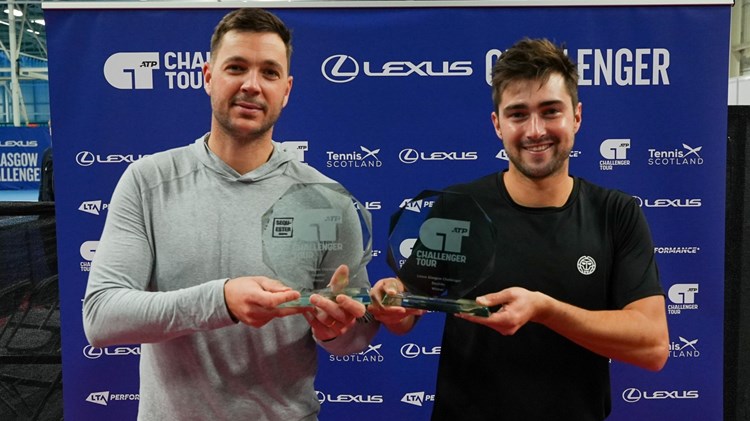 Scott Duncan and Marcus Willis holding their doubles trophies after winning the Lexus Glasgow Challenger
